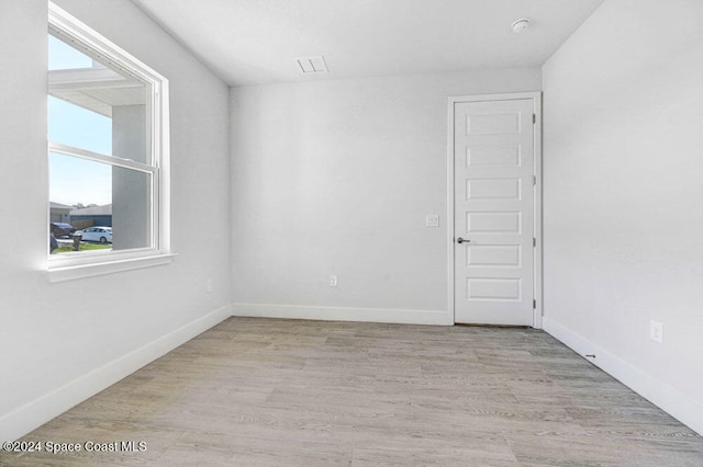 unfurnished room with light hardwood / wood-style flooring