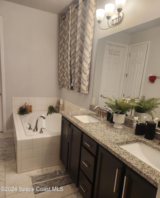 bathroom with vanity and a relaxing tiled tub