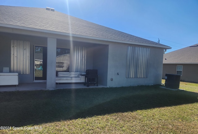 rear view of house with a lawn and a patio area