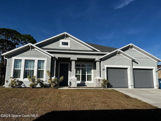 1631 Wake Forest Rd NW, Palm Bay, FL 32907 - view of front facade featuring stucco siding, driveway, a front lawn, and an attached garage