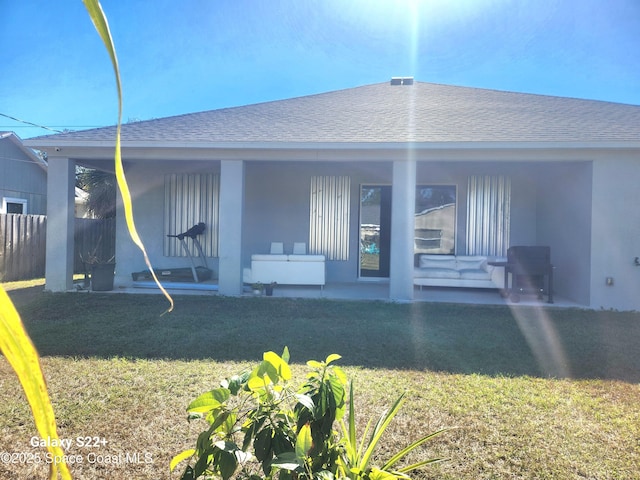 1631 Wake Forest Rd NW, Palm Bay, FL 32907 - rear view of house featuring a yard, covered porch, stucco siding, fence, and a shingled roof