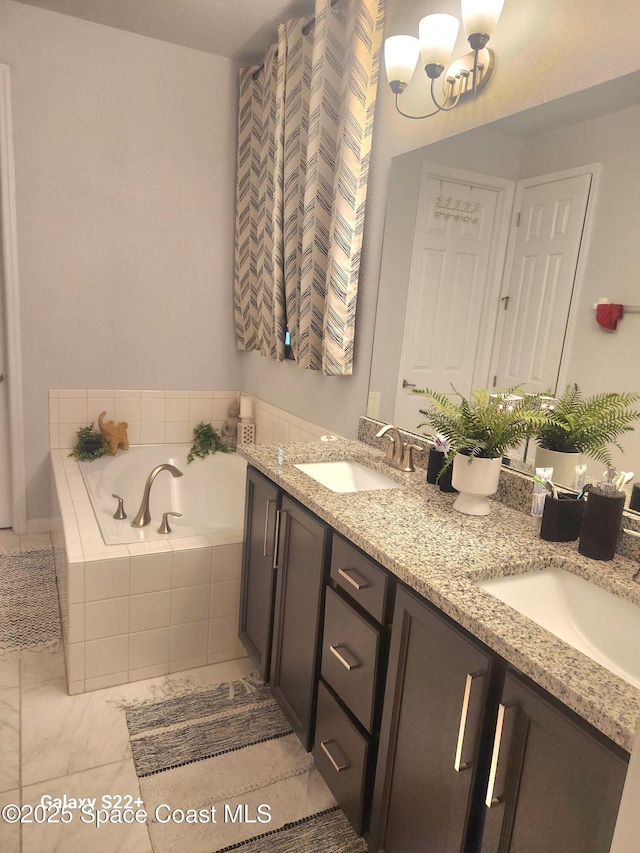 1631 Wake Forest Rd NW, Palm Bay, FL 32907 - bathroom featuring a notable chandelier, double vanity, a bath, and a sink