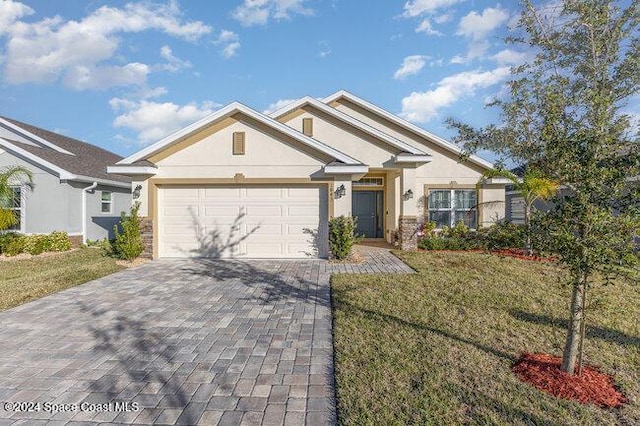 view of front of house with a front yard and a garage