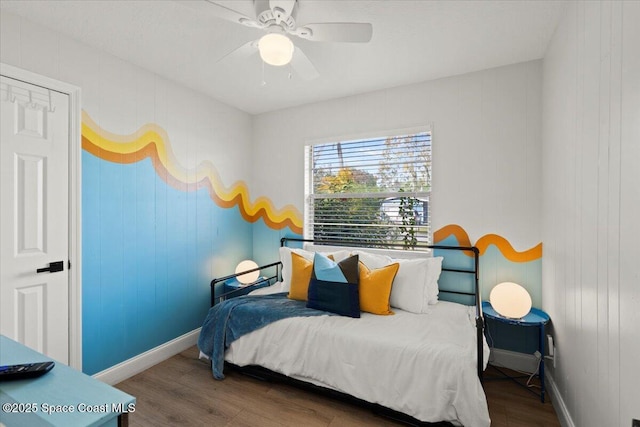 bedroom with wood-type flooring, a closet, and ceiling fan