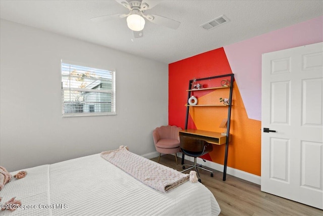 bedroom with ceiling fan and hardwood / wood-style flooring