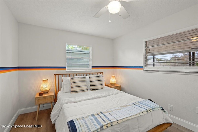 bedroom featuring hardwood / wood-style floors and ceiling fan