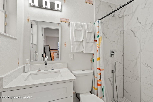 bathroom featuring vanity, toilet, and walk in shower