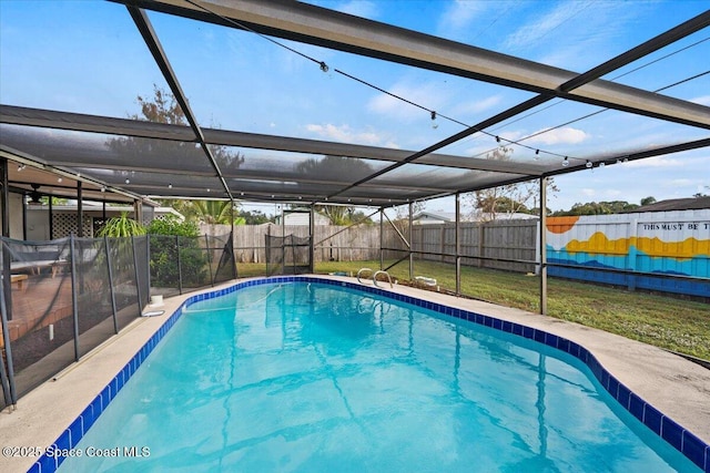 view of pool with a lawn and glass enclosure