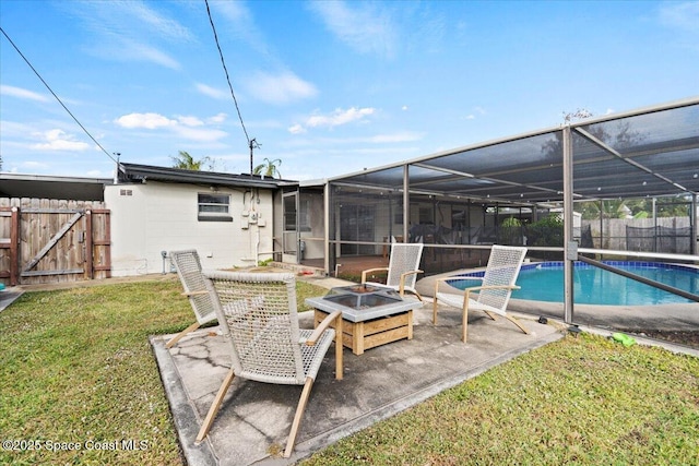 rear view of property featuring a fire pit, a lanai, a yard, and a fenced in pool