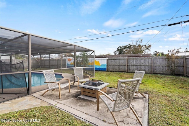 view of patio / terrace with a fire pit, a lanai, and a fenced in pool