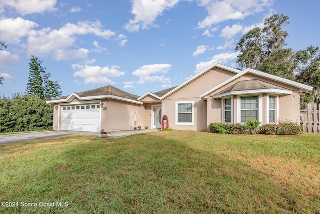 ranch-style home with a front lawn and a garage