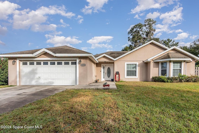 ranch-style home with a front yard and a garage