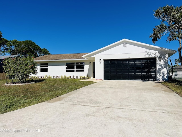 ranch-style home with a front yard and a garage