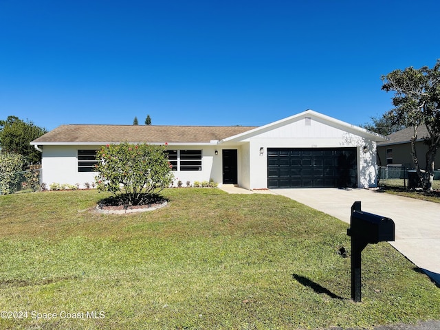 ranch-style home with a front lawn and a garage