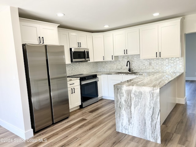 kitchen with white cabinetry, sink, appliances with stainless steel finishes, and tasteful backsplash