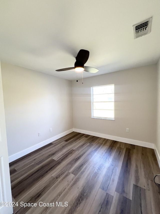 empty room featuring ceiling fan and dark wood-type flooring