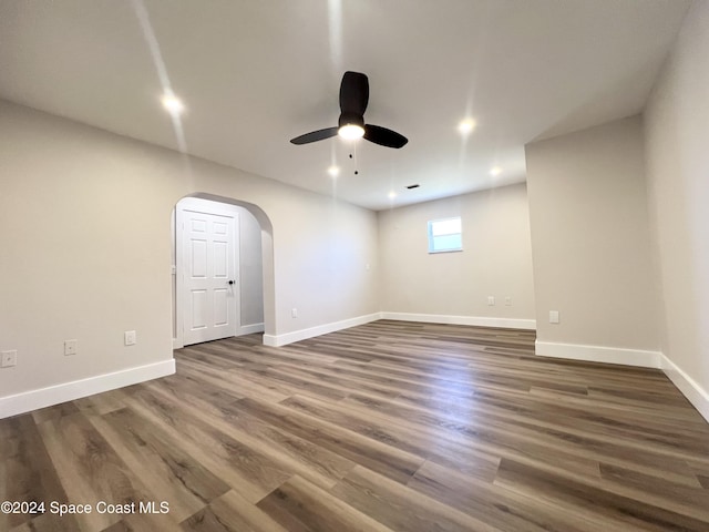 empty room featuring ceiling fan and dark hardwood / wood-style flooring