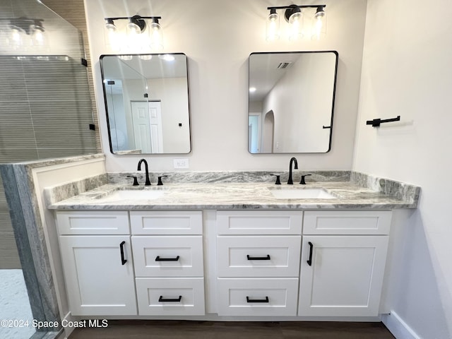 bathroom featuring vanity and a shower