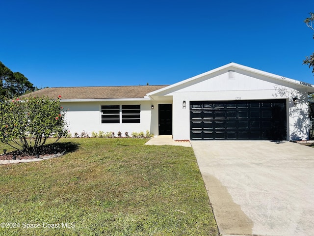 ranch-style home with a front yard and a garage