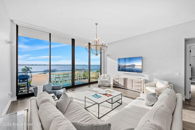 living room with a chandelier, hardwood / wood-style flooring, and expansive windows