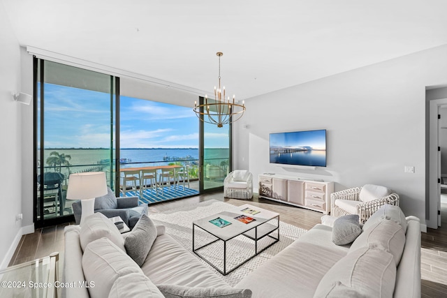 living room with hardwood / wood-style flooring, expansive windows, and a notable chandelier