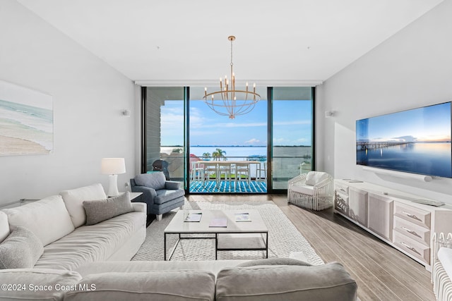 living room featuring light hardwood / wood-style floors, floor to ceiling windows, and an inviting chandelier