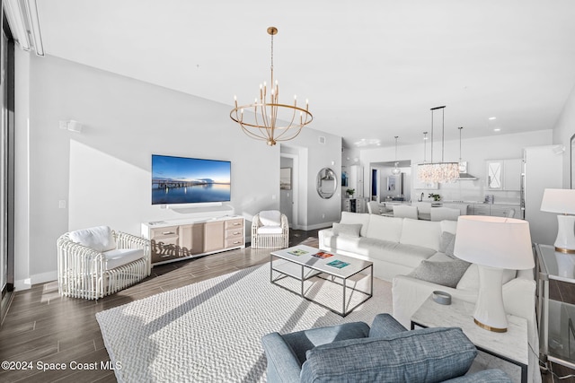 living room with dark hardwood / wood-style floors and an inviting chandelier