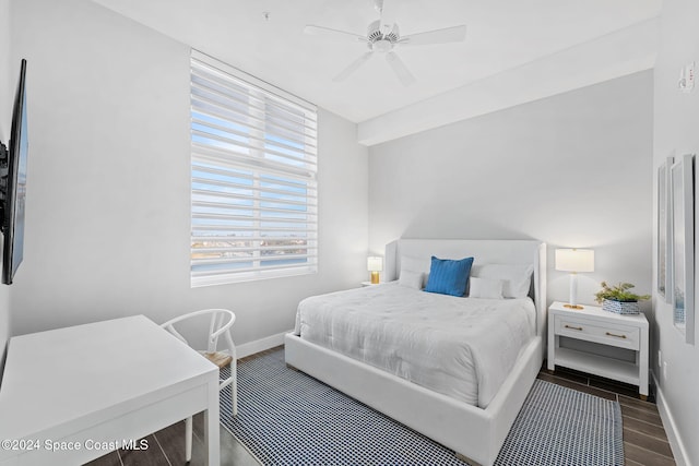 bedroom with dark hardwood / wood-style floors and ceiling fan