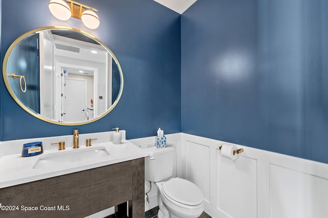 bathroom featuring vanity and toilet