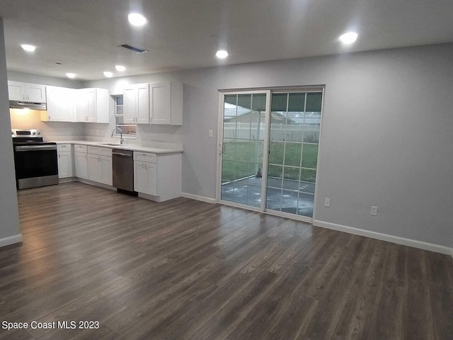 kitchen featuring white cabinets, dark hardwood / wood-style flooring, and stainless steel appliances