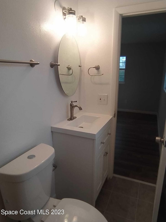 bathroom with tile patterned floors, vanity, and toilet