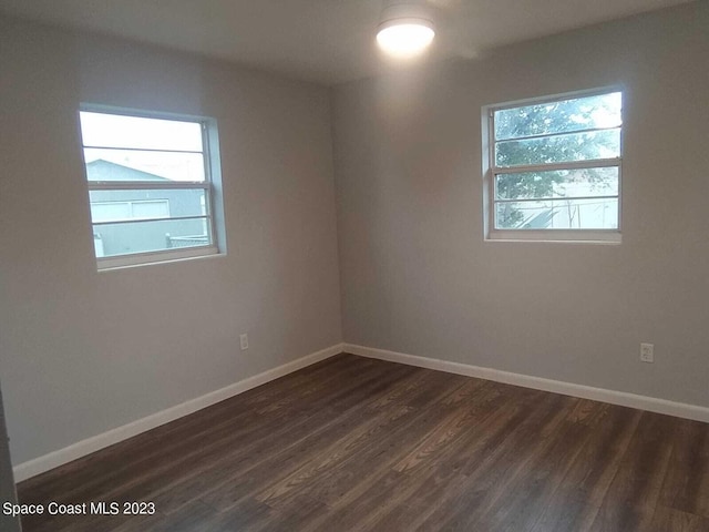 empty room featuring dark hardwood / wood-style flooring