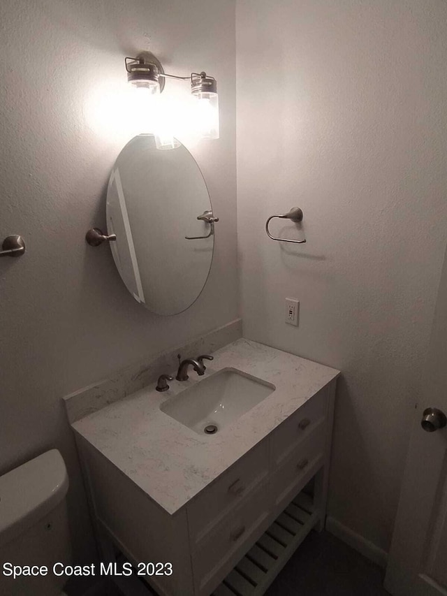 bathroom featuring vanity and toilet