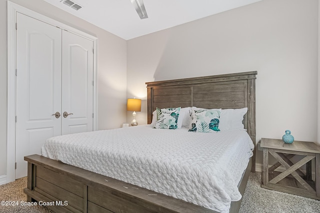 carpeted bedroom featuring ceiling fan and a closet