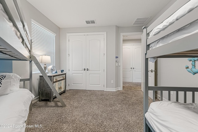 carpeted bedroom featuring a closet