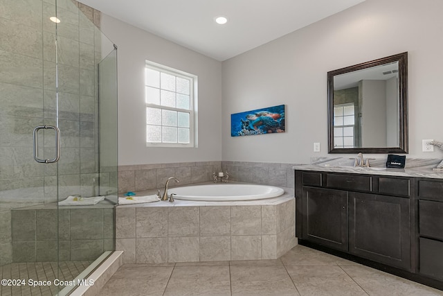 bathroom featuring tile patterned flooring, vanity, and shower with separate bathtub