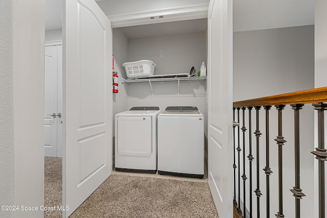 laundry room with washer and dryer and light carpet