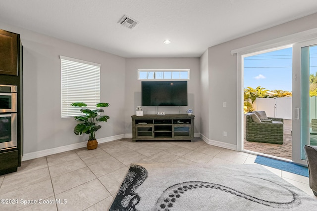 tiled living room featuring a wealth of natural light