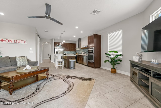 living room with ceiling fan and light tile patterned floors