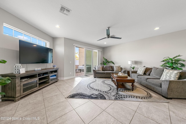 tiled living room featuring ceiling fan