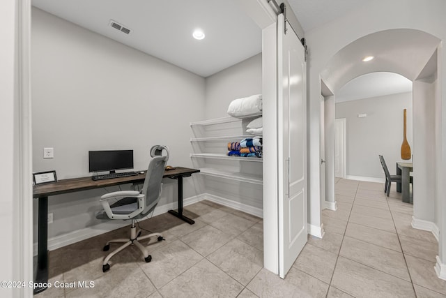 tiled home office with a barn door