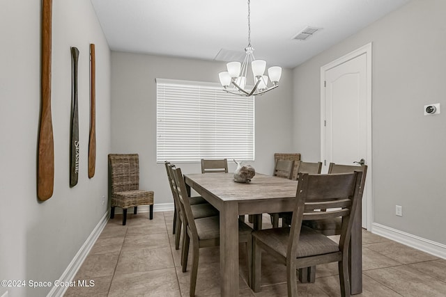 tiled dining area with a notable chandelier