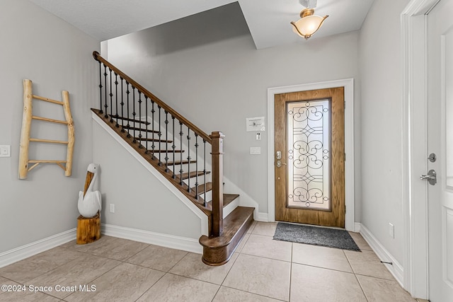 foyer entrance featuring light tile patterned floors