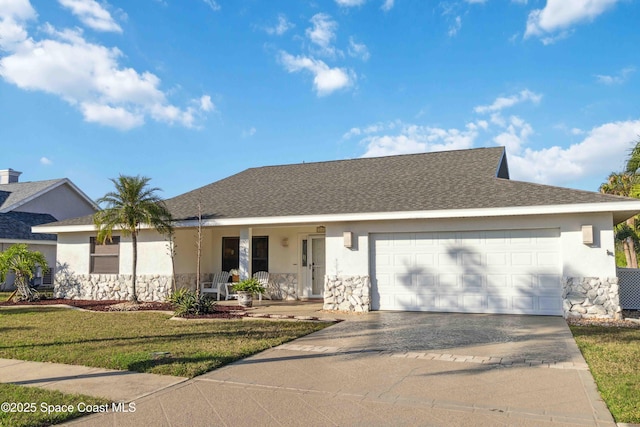 ranch-style house featuring covered porch, a garage, and a front lawn