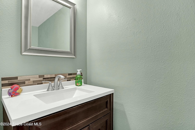 bathroom with vanity and backsplash