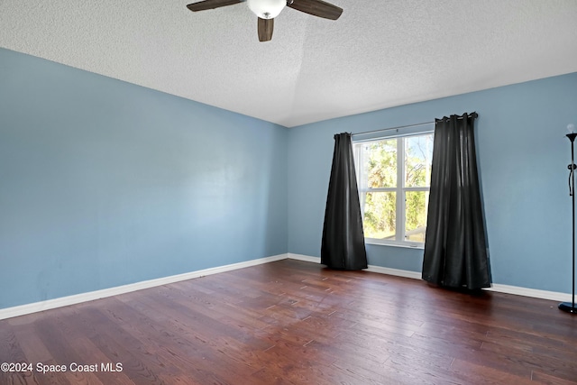 empty room with a textured ceiling, dark hardwood / wood-style flooring, and ceiling fan