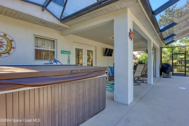 view of patio / terrace featuring a grill and a hot tub