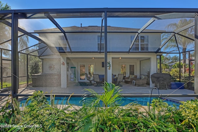 exterior space with an outdoor living space, a lanai, a patio, and french doors