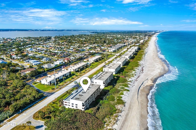 drone / aerial view with a beach view and a water view