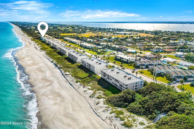 drone / aerial view with a beach view and a water view